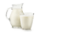 Natural whole milk in a jug and a glass isolated on a white background closeup